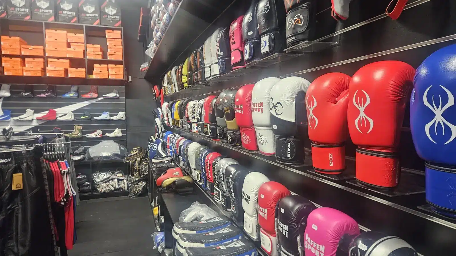 Inside the JU Sports store: walls of boxing gloves, pads and fight shoes